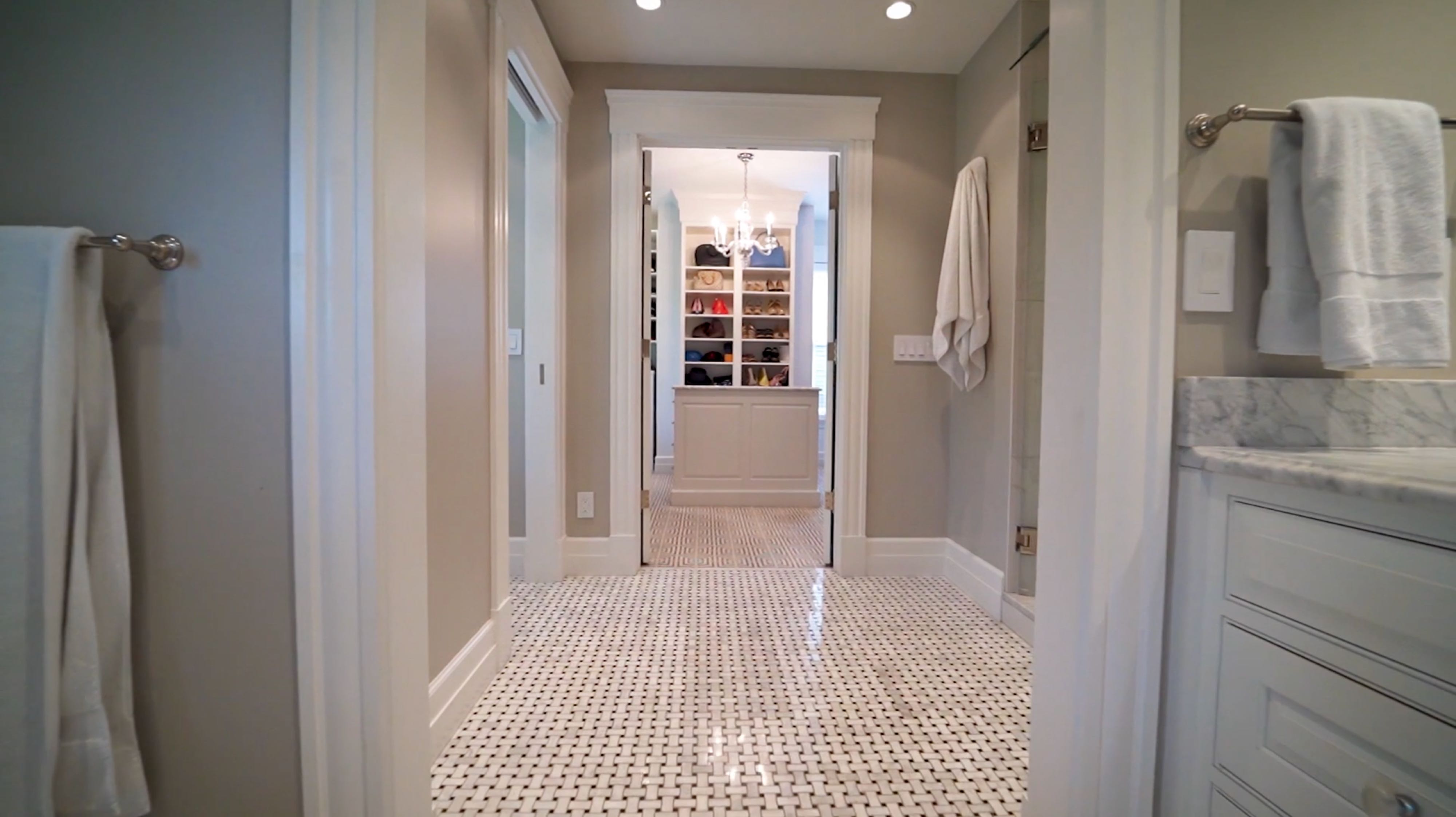 white marble bathroom with walk-in closet